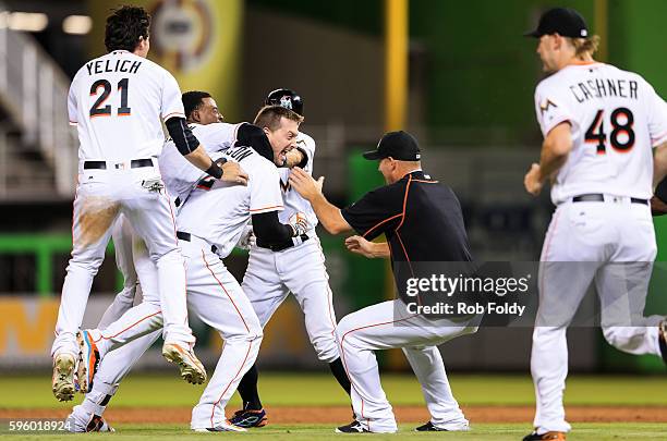 Chris Johnson of the Miami Marlins celebrates with teammates after hitting a walk-off double to end the game against the San Diego Padres at Marlins...