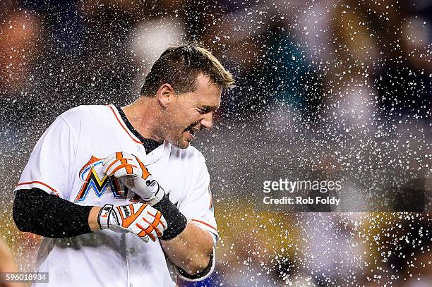 Chris Johnson of the Miami Marlins celebrates with teammates after hitting a walk-off double to end the game against the San Diego Padres at Marlins...