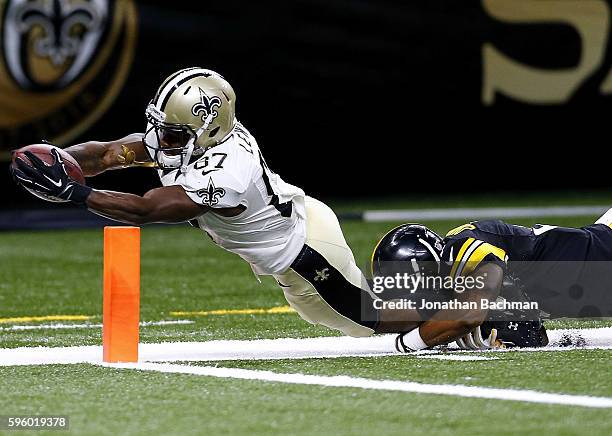 Tommylee Lewis of the New Orleans Saints dives for a touchdown as Jordan Dangerfield of the Pittsburgh Steelers attempts to make the tackle during...