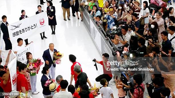 Weightlifting Women's 48kg Bronze Medalist Hiromi Miyake is welcomed by fans on arrival at Narita International Airport on August 14, 2016 in Narita,...