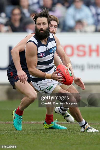 Jimmy Bartel of the Cats gathers the ball during the round 23 AFL match between the Geelong Cats and the Melbourne Demons at Simonds Stadium on...