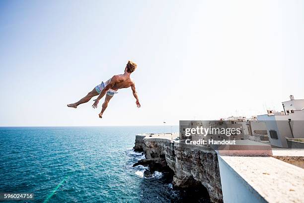 In this handout image provided by Red Bull, Andy Jones of the USA dives from a 25 metre apartment terrace on the morning of the first training...