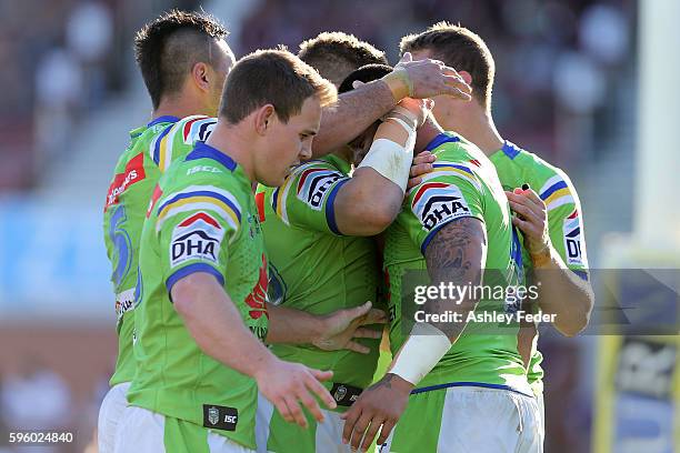 Raiders team mates celebrate the win during the round 25 NRL match between the Manly Sea Eagles and the Canberra Raiders at Brookvale Oval on August...