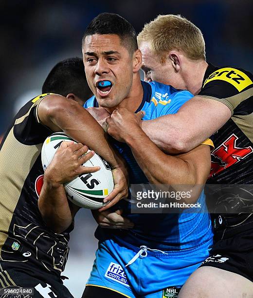 Jarryd Hayne of the Titans is wrapped up by the Panthers defence during the round 25 NRL match between the Gold Coast Titans and the Penrith Panthers...