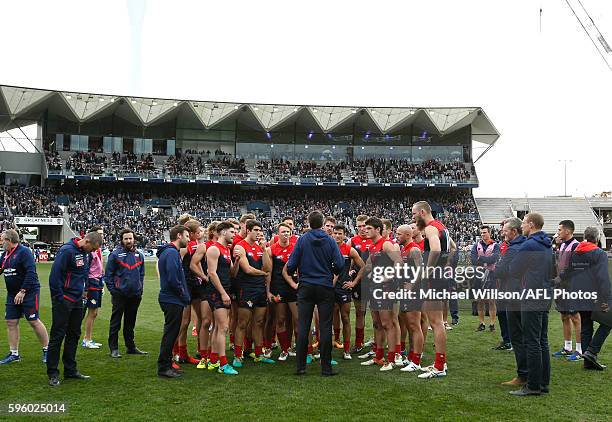 Paul Roos, Senior Coach of the Demons addresses his players for the final time during the 2016 AFL Round 23 match between the Geelong Cats and the...