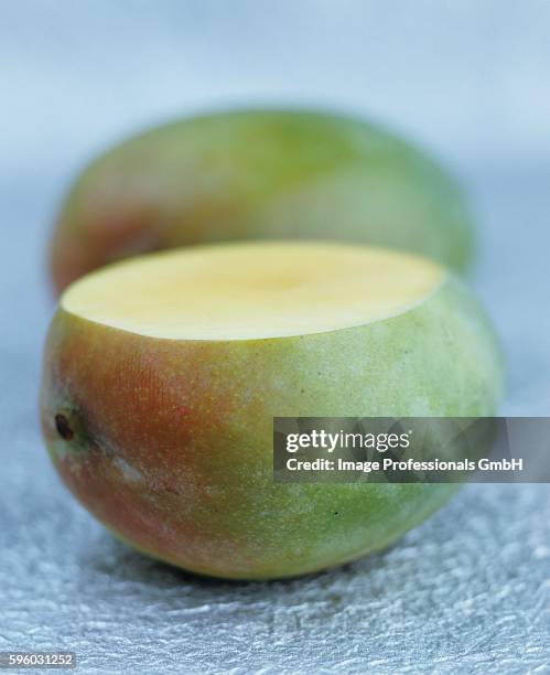 mango with a slice removed - mango slice stock pictures, royalty-free photos & images