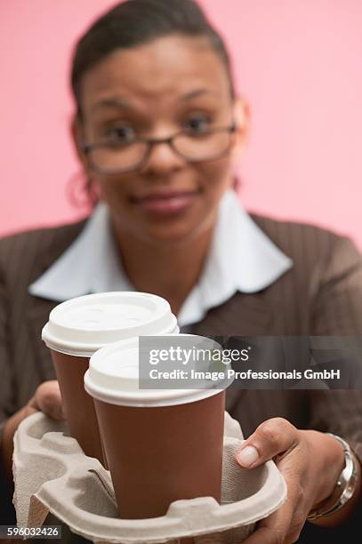 businesswoman offering two cups of coffee - hot secretary stock pictures, royalty-free photos & images