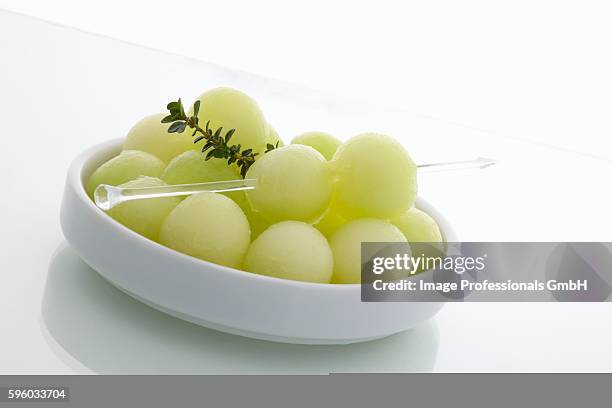 honeydew melon balls in dish with thyme sprig - honeydew melon stock pictures, royalty-free photos & images