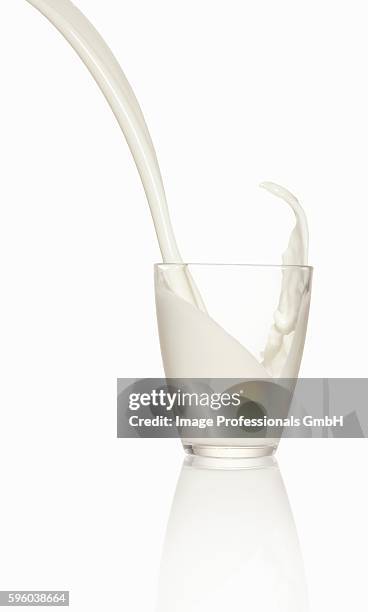 pouring milk into a glass - milk stream stock pictures, royalty-free photos & images