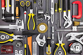 set of hand various work tools on grey background