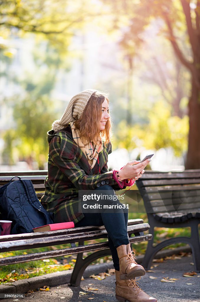 Beautiful young blonde hipster woman listening music