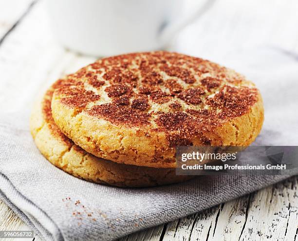 two snickerdoodle cookies on a folded napkin - snickerdoodle stock-fotos und bilder