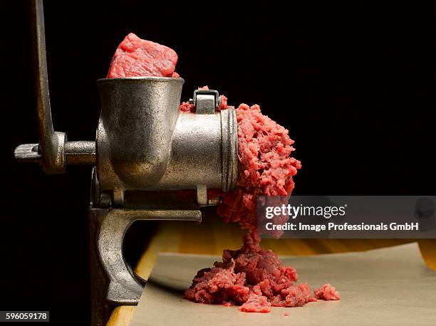 beef in a meat grinder - meat grinder stock pictures, royalty-free photos & images