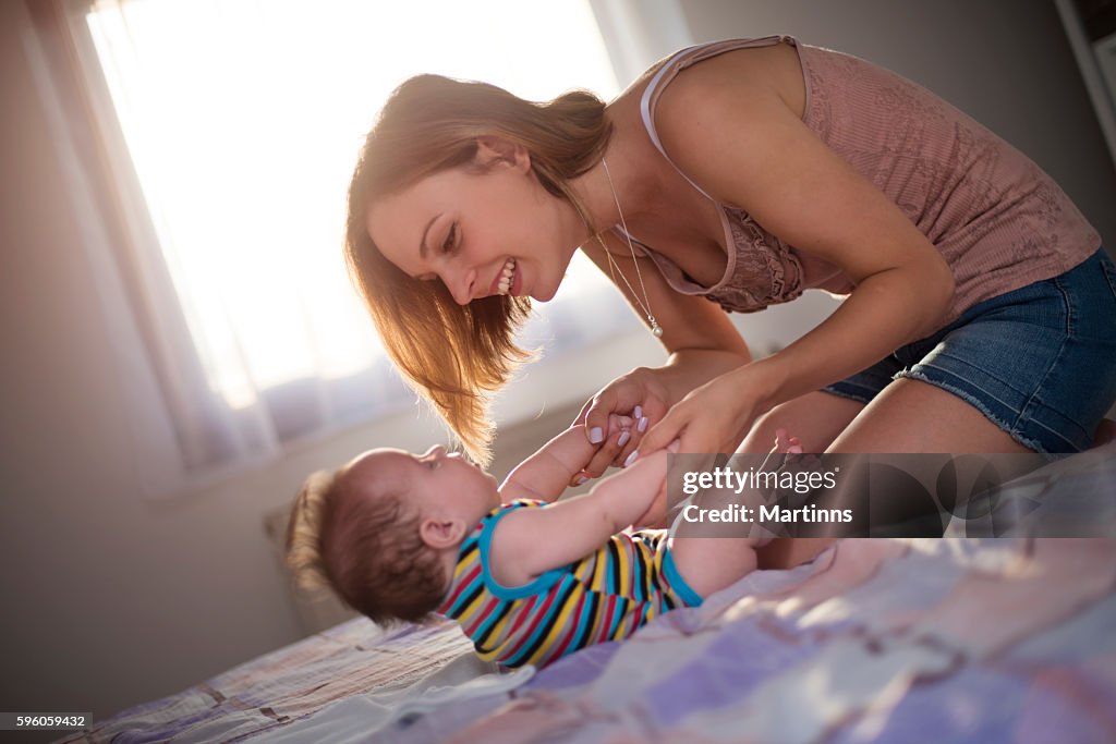 Young mother playing with her baby