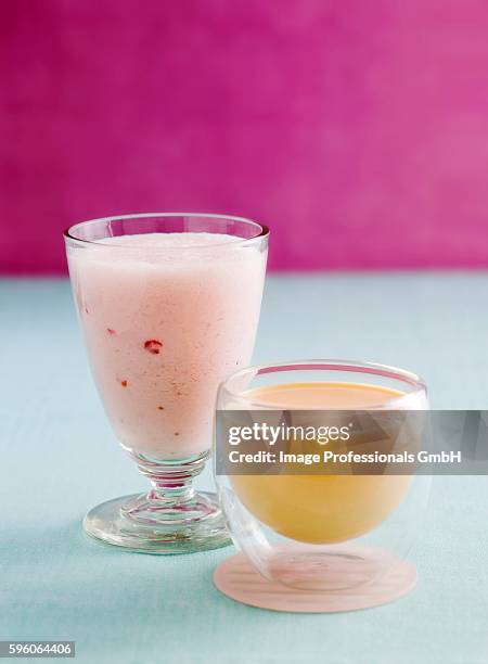 a strawberry smoothie and a mango lassi - lassi stock pictures, royalty-free photos & images