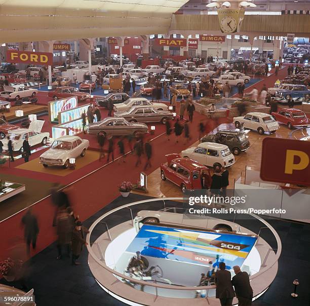 General view of the 38th annual Geneva Motor Show, featuring new car models by Ford, Fiat, Triumph, Simca and Morris on display at Palexpo in Geneva,...