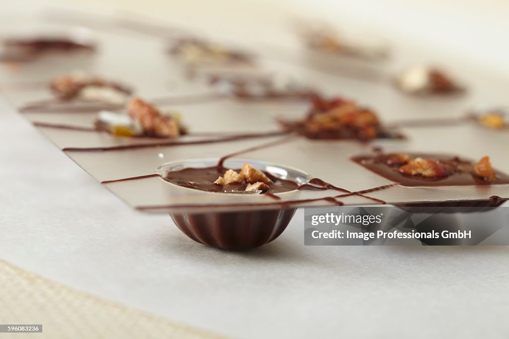 Homemade Chocolates in Molds; Some with Nuts and Some with Bacon