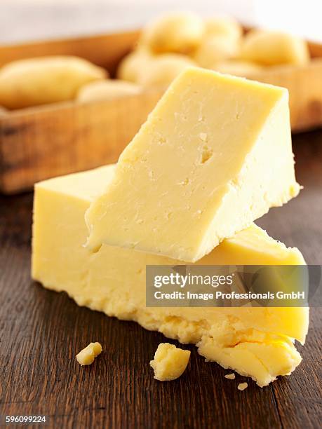 pieces of cheddar cheese stacked - cheddar cheese chunk stock pictures, royalty-free photos & images