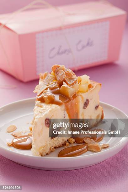 a piece of cheesecake with caramel sauce and slivered almonds - caramel block stock pictures, royalty-free photos & images