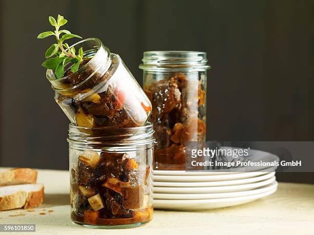 a trio of goulash in preserving jars - stew pot photos et images de collection
