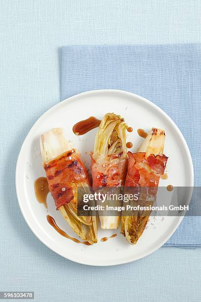 grilled chicory with smoked ham and a honey and balsamic sauce - honey ham stock pictures, royalty-free photos & images