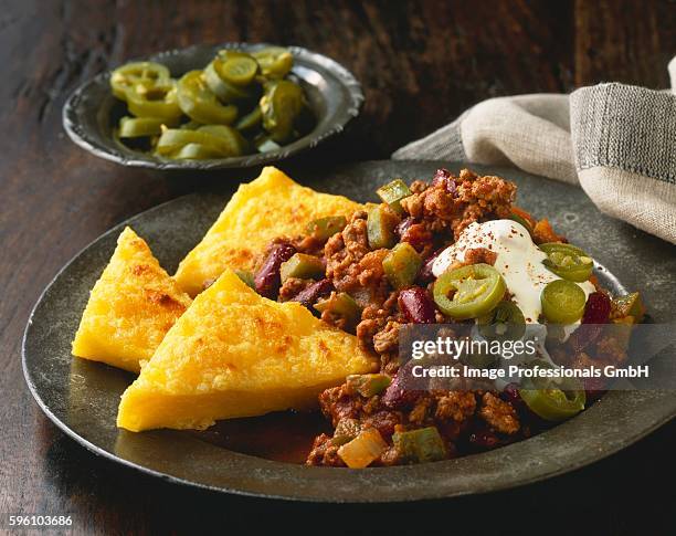 chili con carne with polenta triangles - ground beef stew stock pictures, royalty-free photos & images