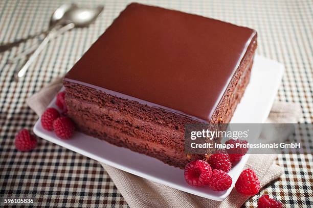 a slice of chocolate cake with fresh raspberries - チョコレートケーキ ストックフォトと画像