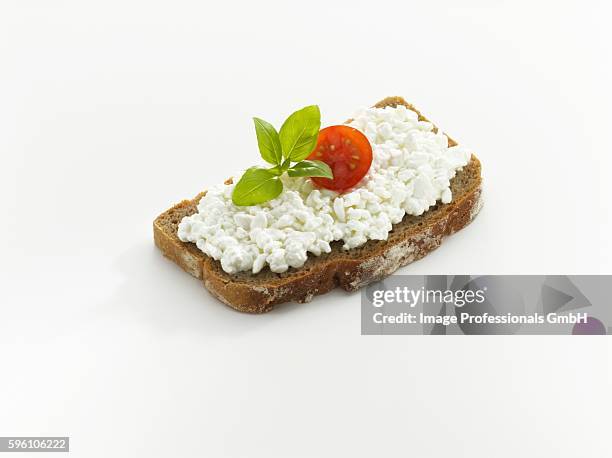 bread topped with cottage cheese, tomato and basil - basil stock-fotos und bilder