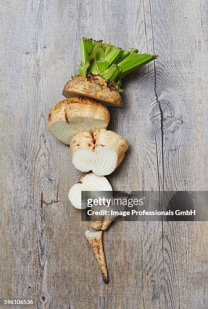 a sliced raw sugar beet on a wooden surface - suikerbiet stockfoto's en -beelden