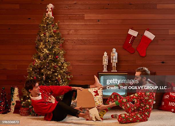 spoiled man-brats fight over gift. - row of christmas trees stock pictures, royalty-free photos & images