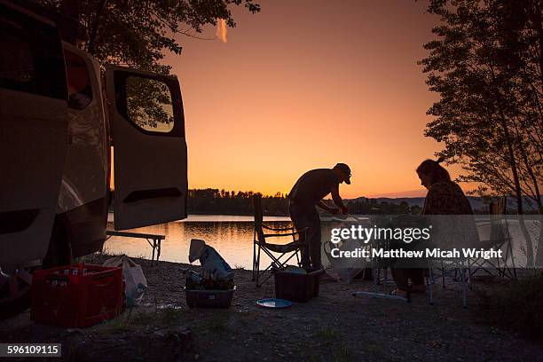 couples enjoy a sunset from inside a camper. - slovakia stock pictures, royalty-free photos & images