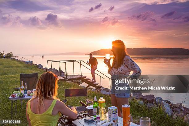 a sunset dinner at a lakeside campsite. - balaton hungary stock pictures, royalty-free photos & images