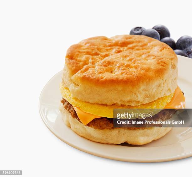 sausage egg and cheese breakfast sandwich on a biscuit; white background - english muffin stock pictures, royalty-free photos & images
