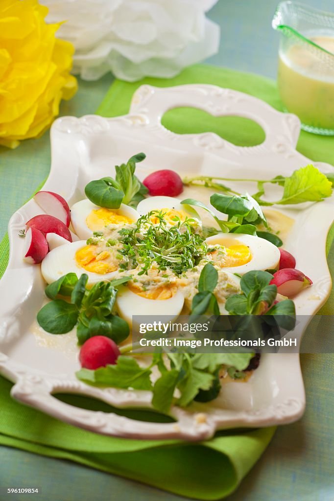 Hard-boiled eggs with horseradish, radishes, lamb's lettuce and cress for Easter