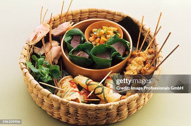 pancake rolls and skewers in a basket - tuna wrap stock pictures, royalty-free photos & images