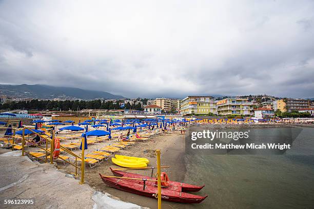 a beach on the italian riviera. - san remo italië stockfoto's en -beelden