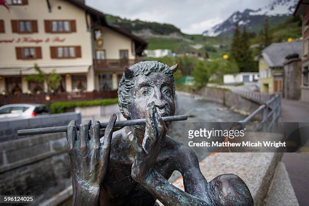a statue of the mythical pan in the alps. - town of the gods stock pictures, royalty-free photos & images