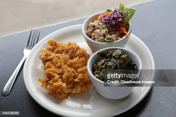 macaroni and cheese with collard greens and chickpea salad - macaroni salad stock pictures, royalty-free photos & images