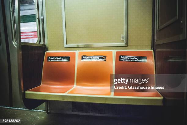 empty seats on subway car with priority seating stickers, new york city, usa - seat stock pictures, royalty-free photos & images