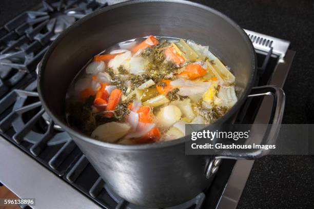 simmering pot of turkey vegetable soup - soup vegtables stock-fotos und bilder