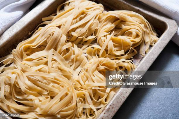 uncooked linguine pasta in pan - linguine ストックフォトと画像