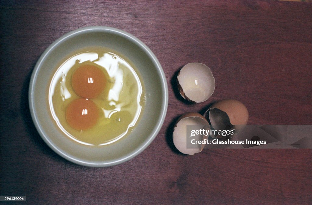 Egg Shells Next to Raw Eggs in Dish