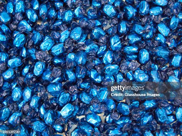 candy in blue wrapping - candy wrapper stock pictures, royalty-free photos & images