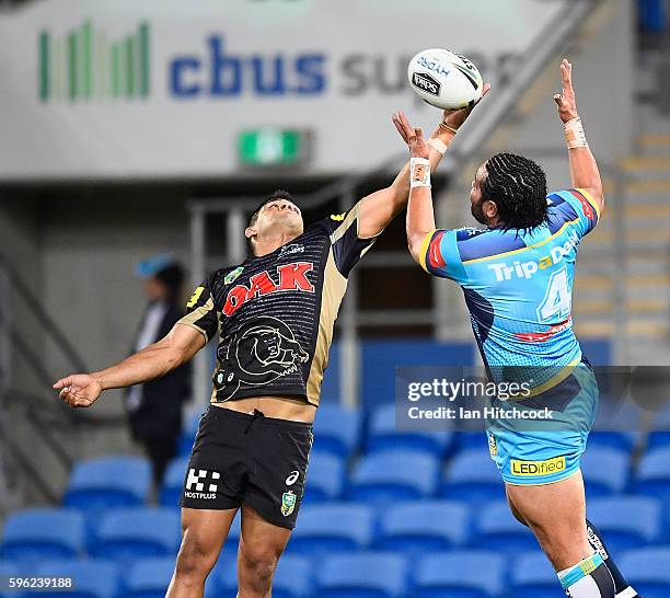 Konrad Hurrell of the Titans contests the ball with Tyrone Peachey of the Panthers during the round 25 NRL match between the Gold Coast Titans and...