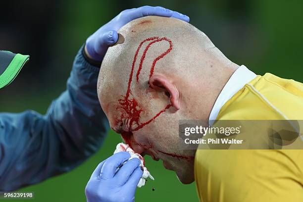 Stephen Moore of Australia is cut on the head during the Bledisloe Cup Rugby Championship match between the New Zealand All Blacks and the Australia...
