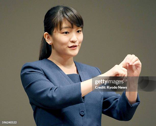 Princess Mako, the eldest daughter of Prince Akishino and Princess Kiko, uses sign language as she addresses an opening ceremony for a national high...