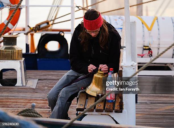 Member of a ships crew polishes brasswork on deck during the North Sea Tall Ships Regatta on August 27, 2016 in Blyth, England. The bustling port...