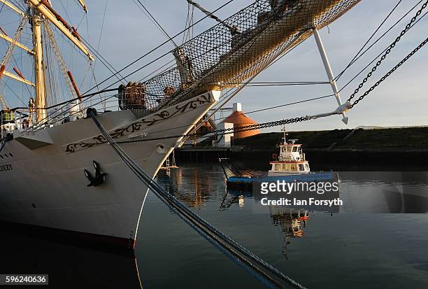 Tugboat sails past the Polish ship Dar Mlodziezy during the North Sea Tall Ships Regatta on August 27, 2016 in Blyth, England. The bustling port town...