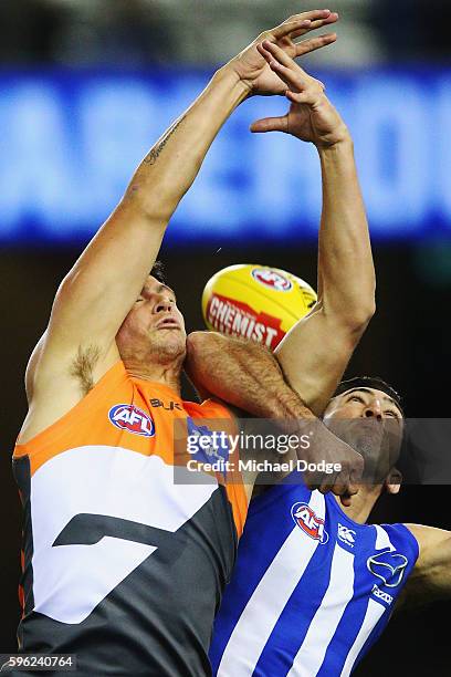 Jonathon Patton of the Giants and Michael Firrito of the Kangaroos compete for the ball during the round 23 AFL match between the North Melbourne...