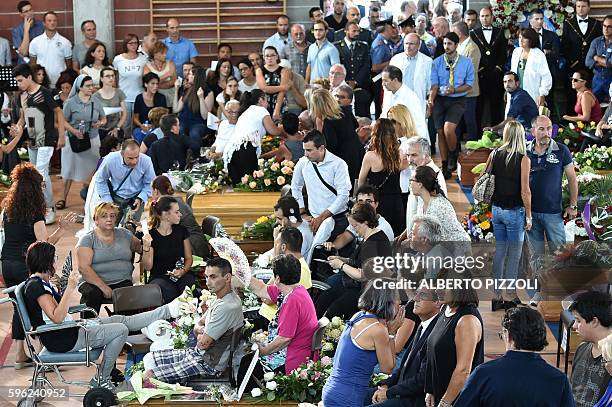 Relatives of earthquake victims gather in a gymnasium arranged in a chapel of rest on August 27 in Ascoli Piceno, three days after a 6.2-magnitude...